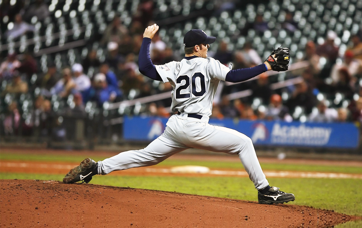 Baseball pitcher mid pitch at a professional baseball game