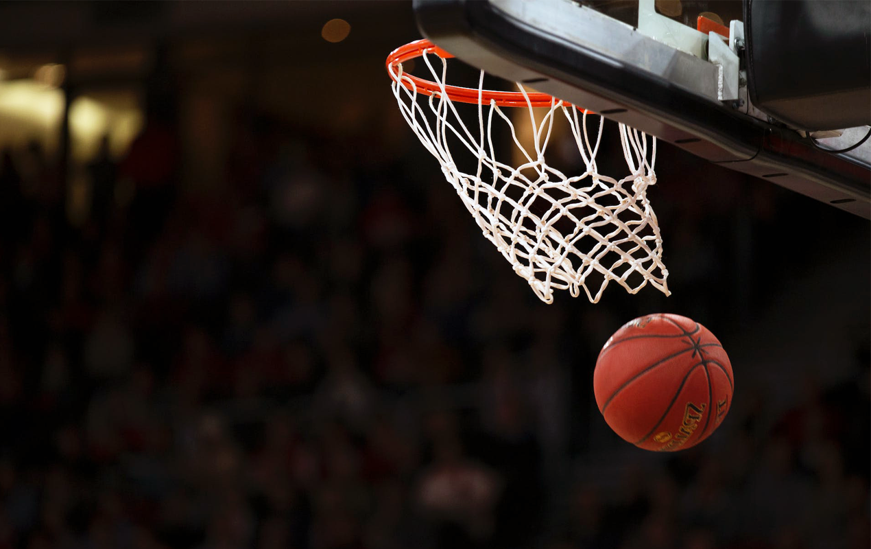 Basketball going through a basketball hoop in at a professional basketball game