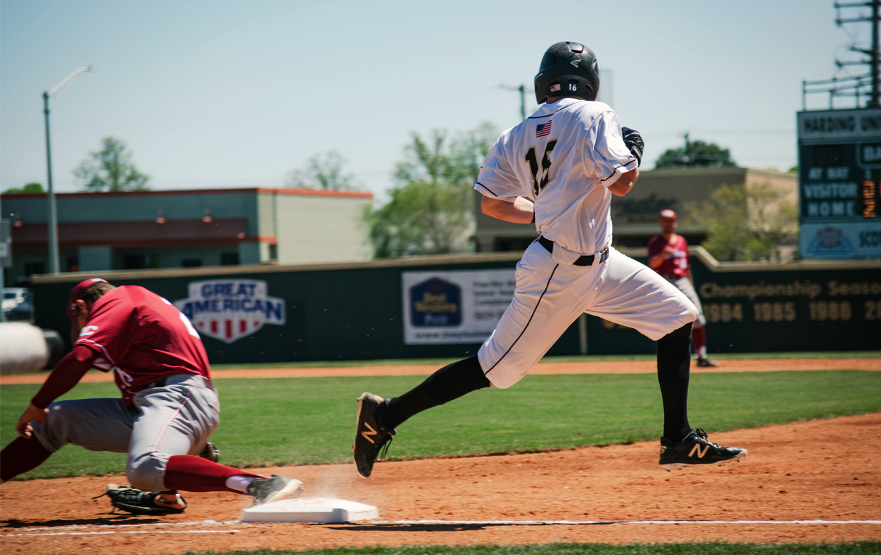 Baseball player crossing home during a professional baseball game similar to MLB